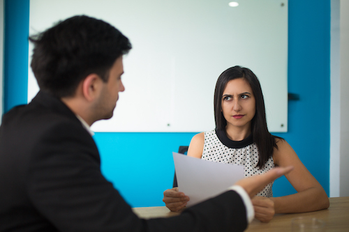 A woman looking disappointed during an assessment