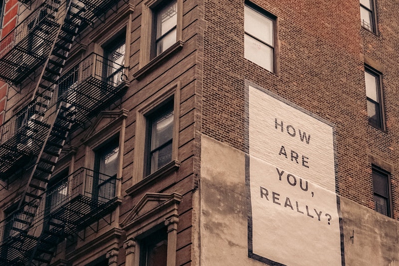 "How Are You, Really?" sign on side of building