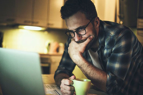 A guy looking at his laptop