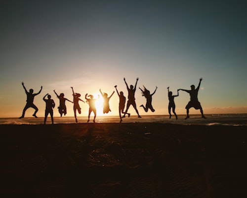 Team jumping in victory