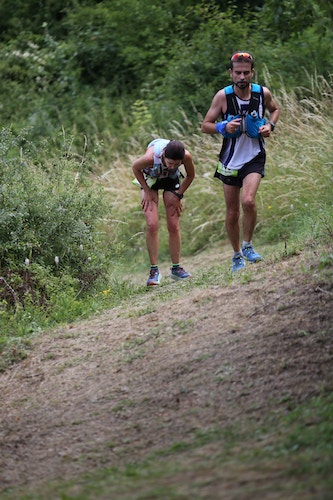 Two people running up a hill